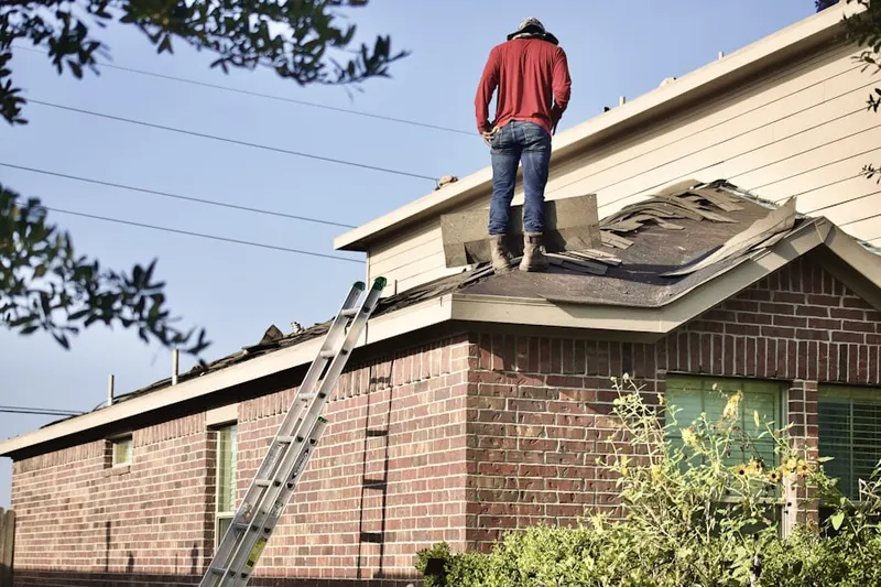 Professional roofer working on a residential roof in Bayside Lakes Commercial Center